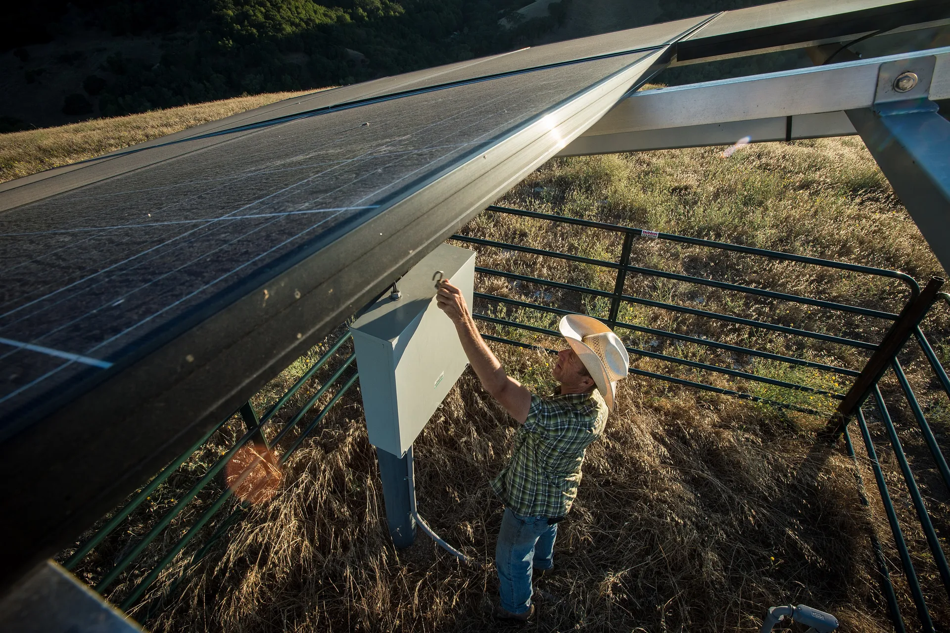 Solar photovoltaic array mounted over a groundwater pumping system