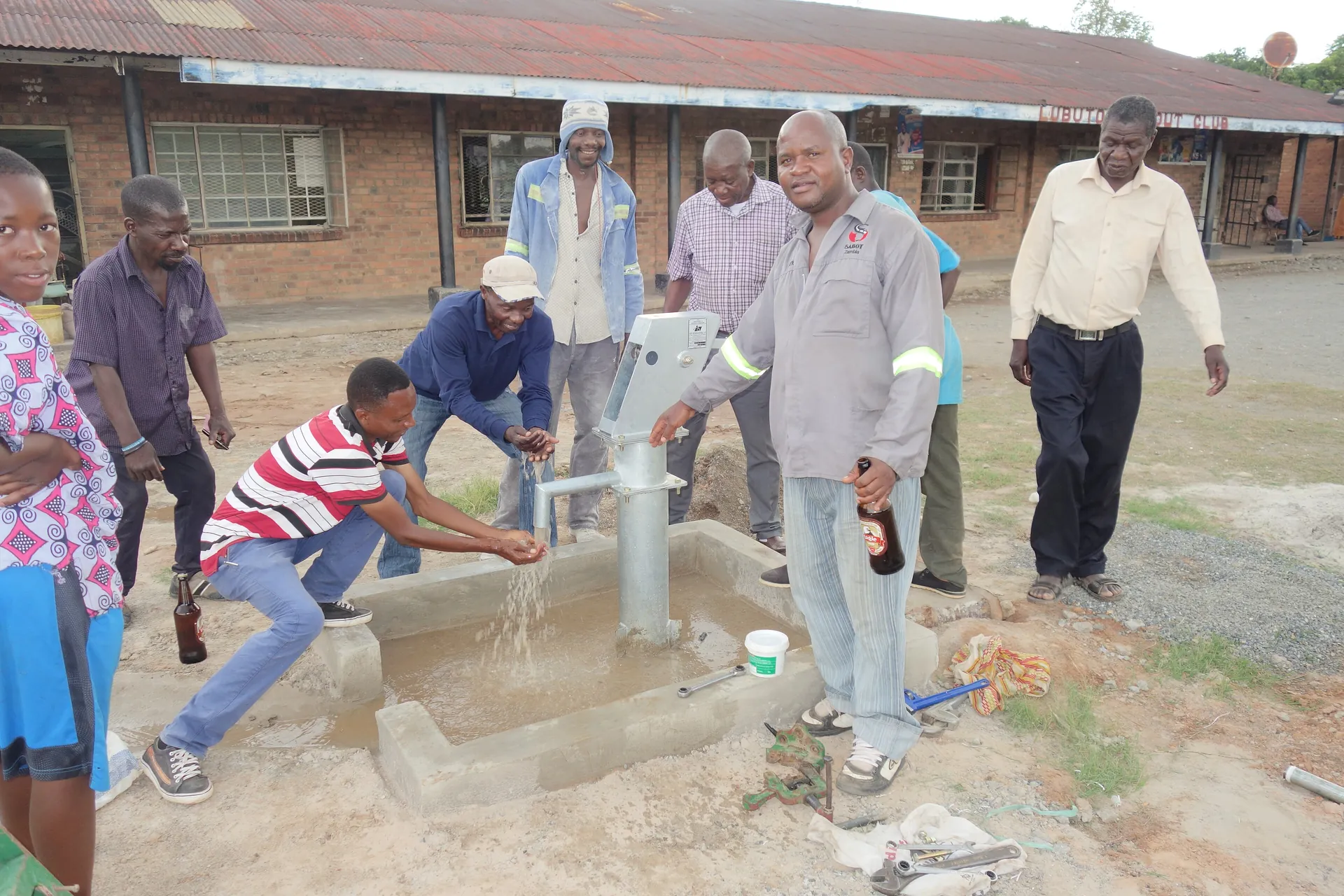Community members drawing clean water from a newly installed borehole tap
